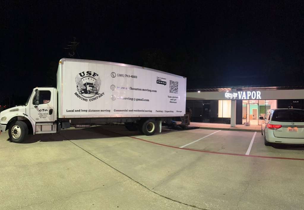 USF Moving Company truck at a commercial site in Houston, TX, providing professional moving services.