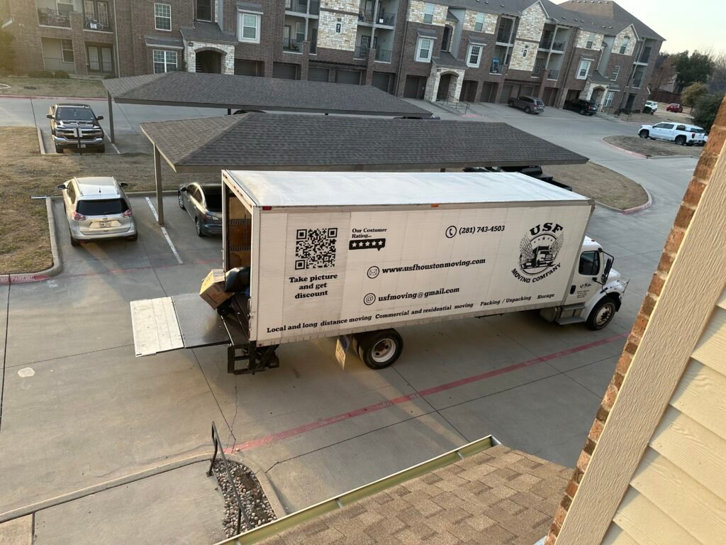 USF Moving Company truck providing residential moving services at a Pasadena, TX apartment complex.